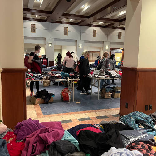 Tables are filled with colorful clothing as guests check out the options at Wear the Rainbow in 2024.